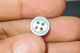 Laser engraved branding in buttons